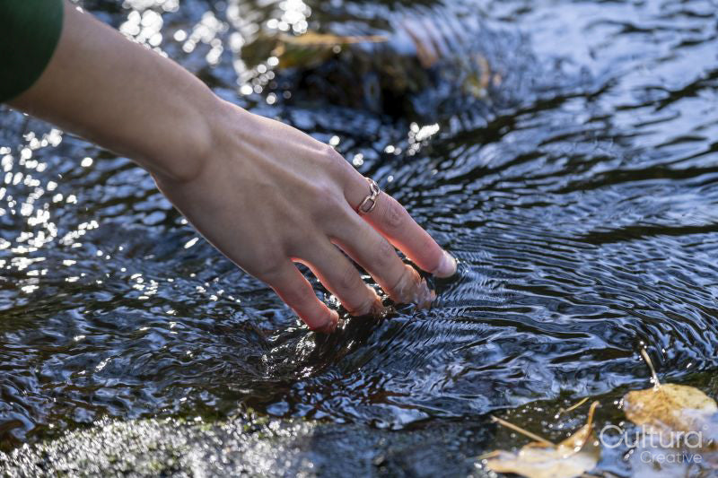 Close-up of woman''s hand at stream