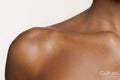 Studio close up of a shoulder and collar bone of a woman