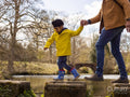 Father with son on stepping stones on lake