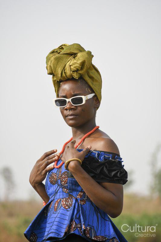 Portrait of young woman wearing headscarf and sunglasses