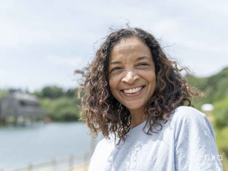 Portrait of smiling woman by lake