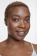 Studio portrait of smiling woman with nose ring