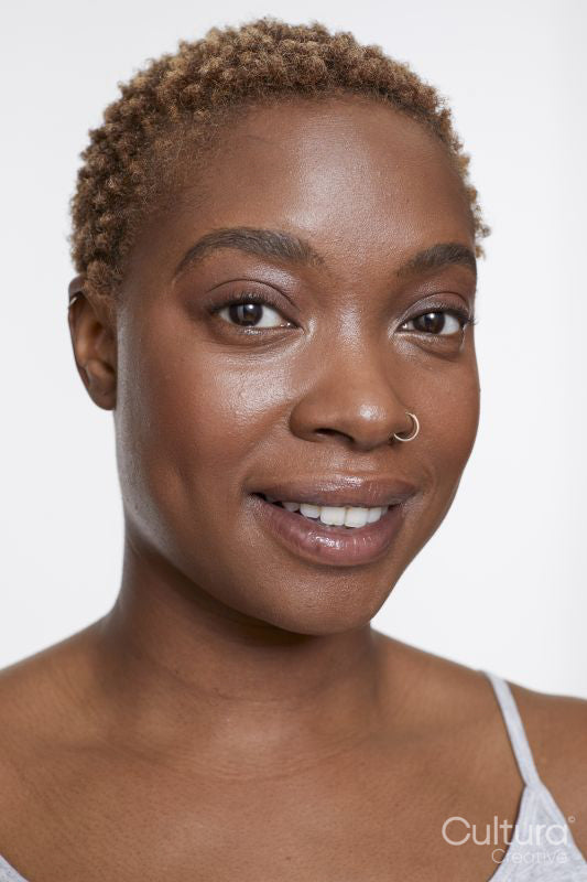 Studio portrait of smiling woman with nose ring