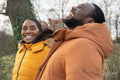 Couple in winter jackets walking in rural setting