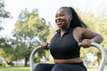 Young woman exercising in outdoor gym