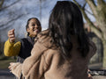 Two young women meeting in street