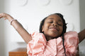 Smiling girl throwing hands in air