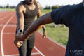 Two athletes running in relay race