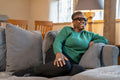 Smiling senior woman relaxing on sofa at home