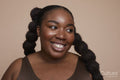 Studio shot of smiling young woman with braided hair