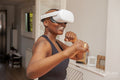 Mature woman practicing boxing with virtual reality simulator