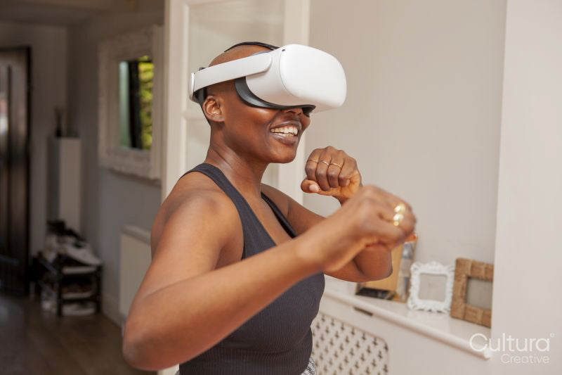 Mature woman practicing boxing with virtual reality simulator