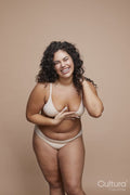 Studio portrait of smiling young woman wearing lingerie