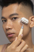 Studio portrait of person using face roller