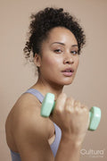 Studio portrait of woman exercising with dumbbells