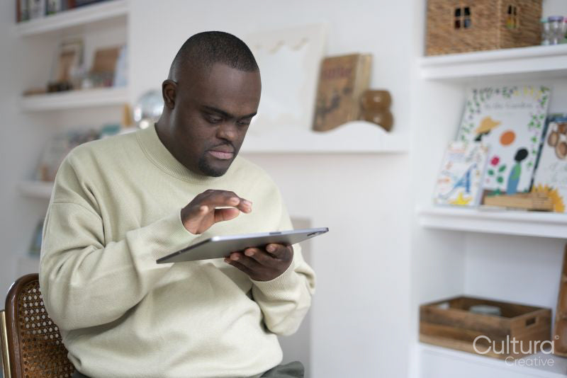 Man with Down syndrome using tablet