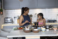 Mother and daughter cooking in kitchen