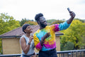 Friends smiling at taking selfie on rooftop terrace