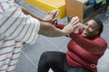 Daughter helping mother practicing sit-ups in gym