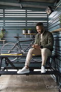Man sitting in lounge room and using phone