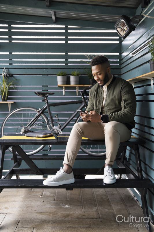 Man sitting in lounge room and using phone