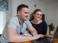 Smiling couple online shopping at home