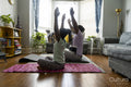 Father and daughter practicing yoga at home