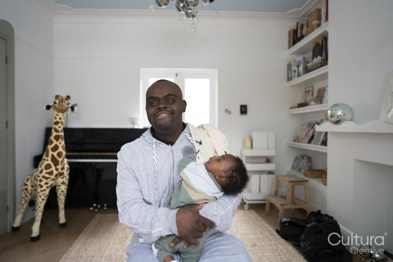 Man with Down syndrome holding baby boy