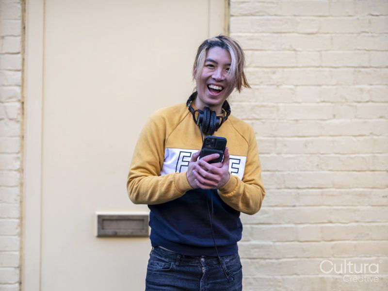 Portrait of laughing man with smart phone