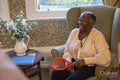 Smiling senior woman playing with racket in nursing home