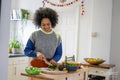 Smiling young woman cooking at home