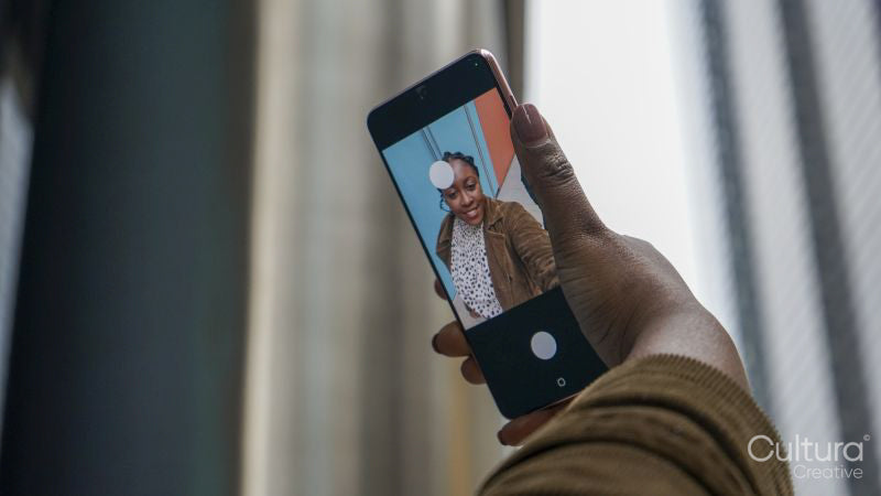 Woman using phone to take selfie, close up of hand