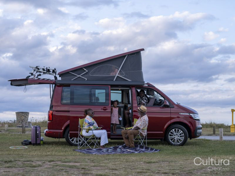 Family with girl camping in camper van