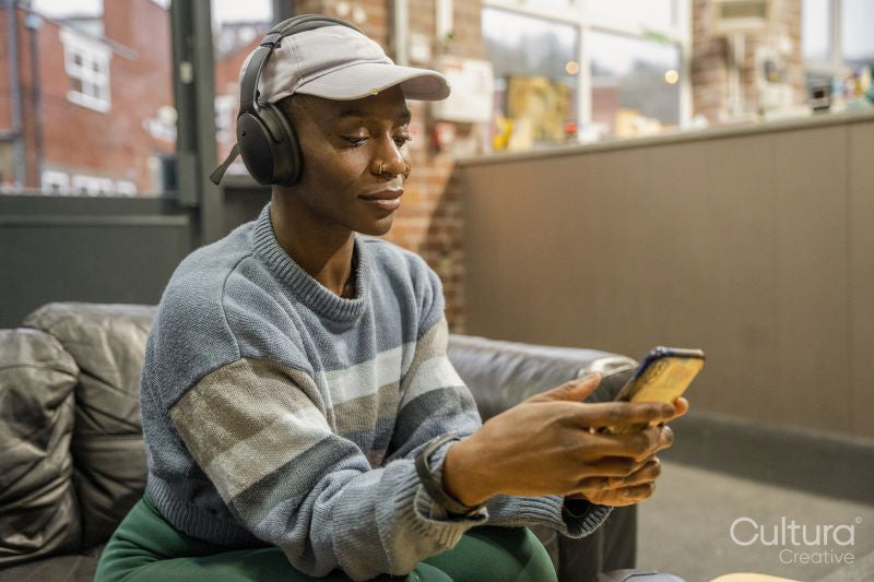 Woman with headphones looking at smart phone