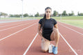 Female athlete preparing to run at stadium