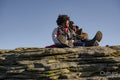 Two women relaxing on top of rock