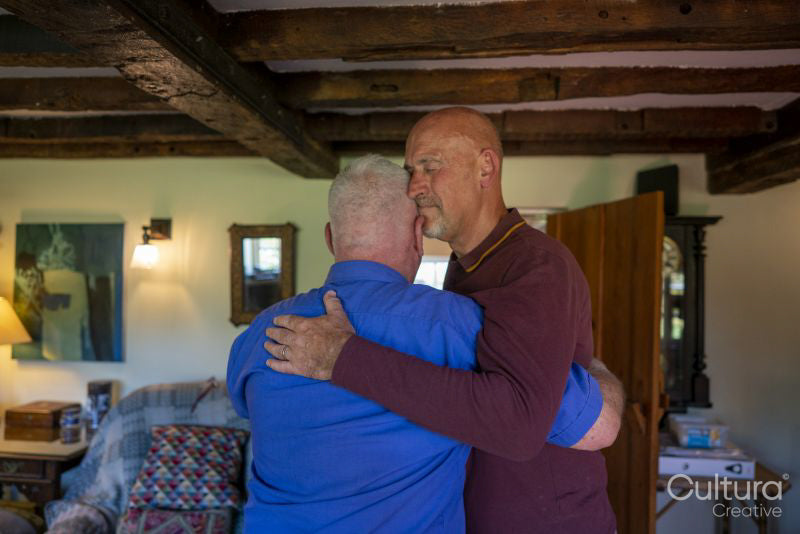 Senior male couple playing dancing at home