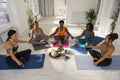 High angle view of women meditating in yoga studio