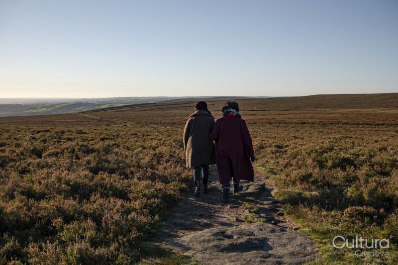 Rear view of two women hiking in moorland
