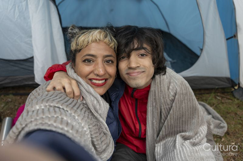 Portrait of mother and son sitting in tent