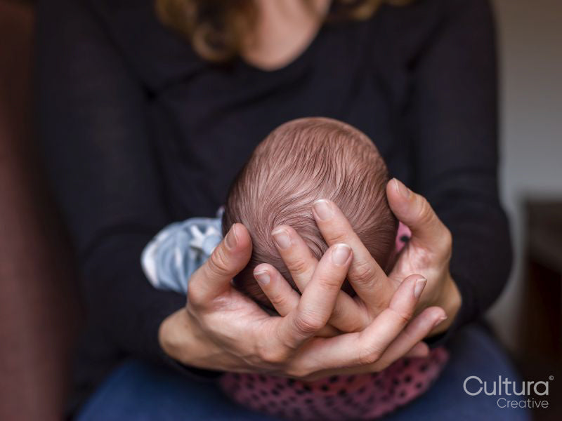 Close-up of woman holding baby son