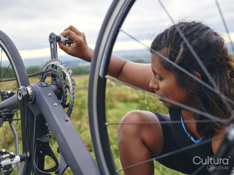 Woman checking bicycle before ride