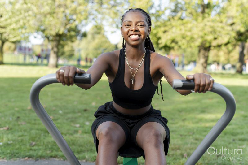 Young woman exercising in outdoor gym