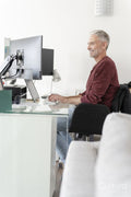 Mature man working on computer at home