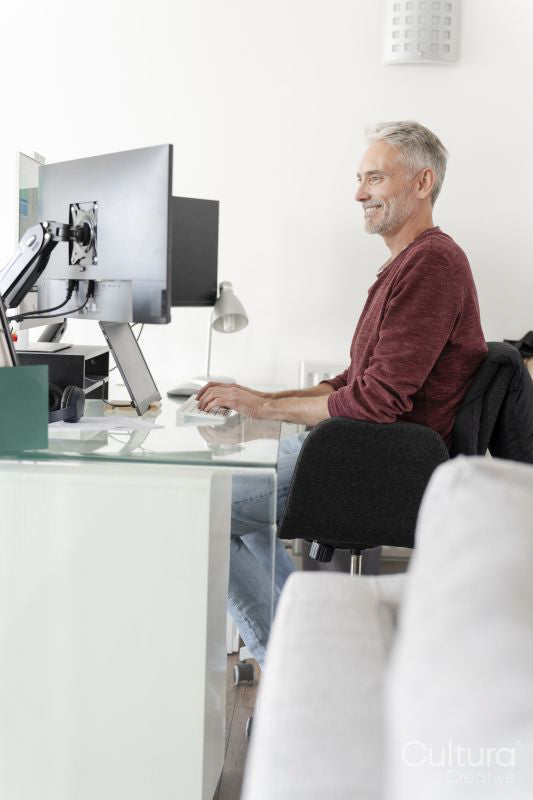 Mature man working on computer at home