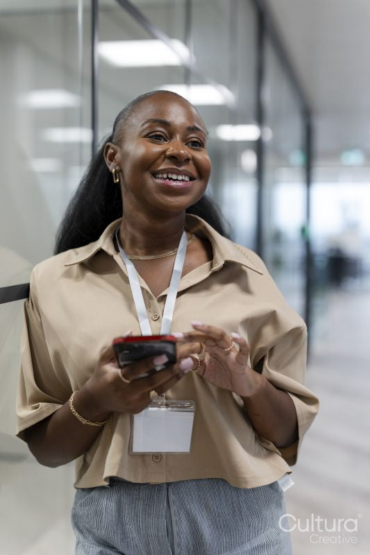 Happy businesswoman in office corridor