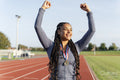 Portrait of female athlete celebrating with medal