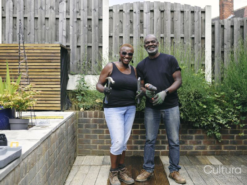 Couple with construction tools on patio
