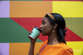 Young woman drinking take-out coffee outdoors