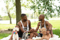 Louisiana, couple with dogs having picnic on lawn in park